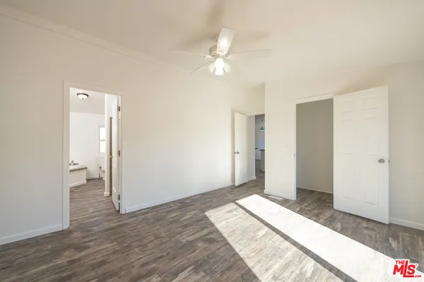 a view of a room with wooden floor and white walls