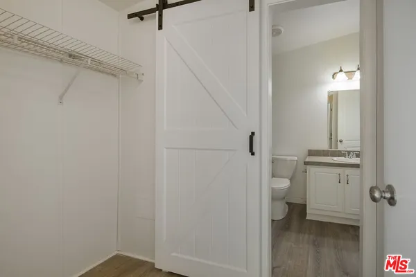 a bathroom with a granite countertop toilet and a sink