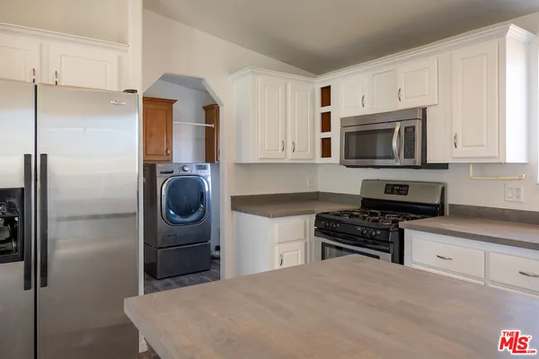 a kitchen with a refrigerator stove and microwave