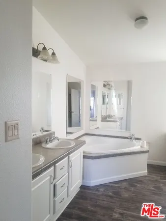 a spacious bathroom with a sink and a mirror