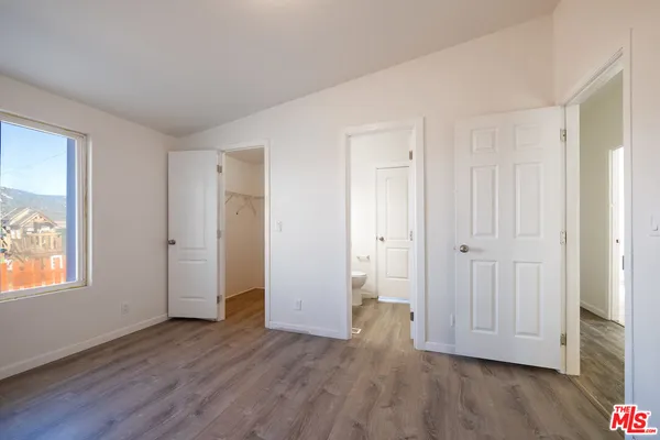 a view of a livingroom with wooden floor and window