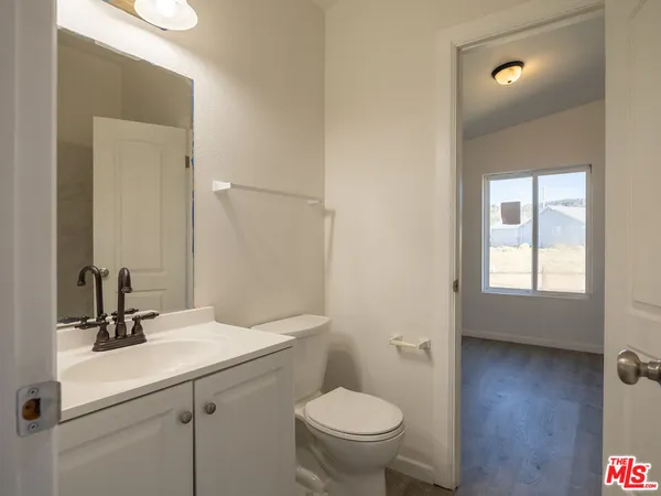 a bathroom with a sink toilet and mirror