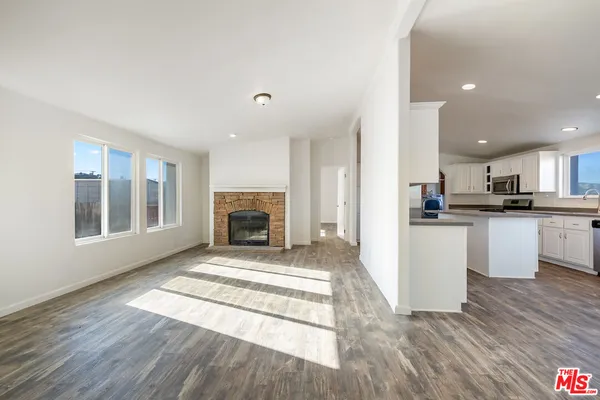 a view of kitchen with granite countertop cabinets and wooden floor