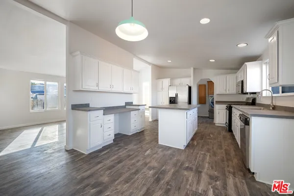 a kitchen with white cabinets and white appliances