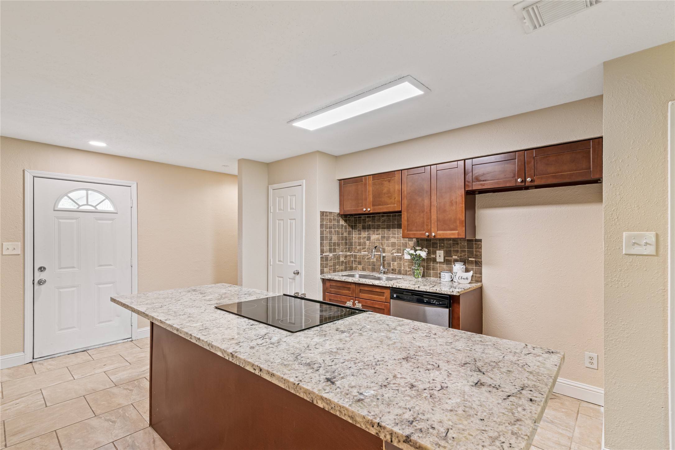 16027 Barbara Lane Magnolia, TX 77355 - Photo 11 of 40 a kitchen with stainless steel appliances granite countertop a sink refrigerator and cabinets