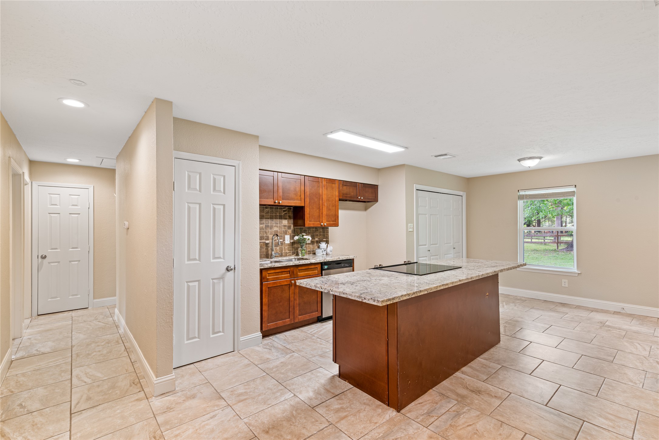 16027 Barbara Lane Magnolia, TX 77355 - Photo 12 of 40 a kitchen with granite countertop a sink stove and cabinets