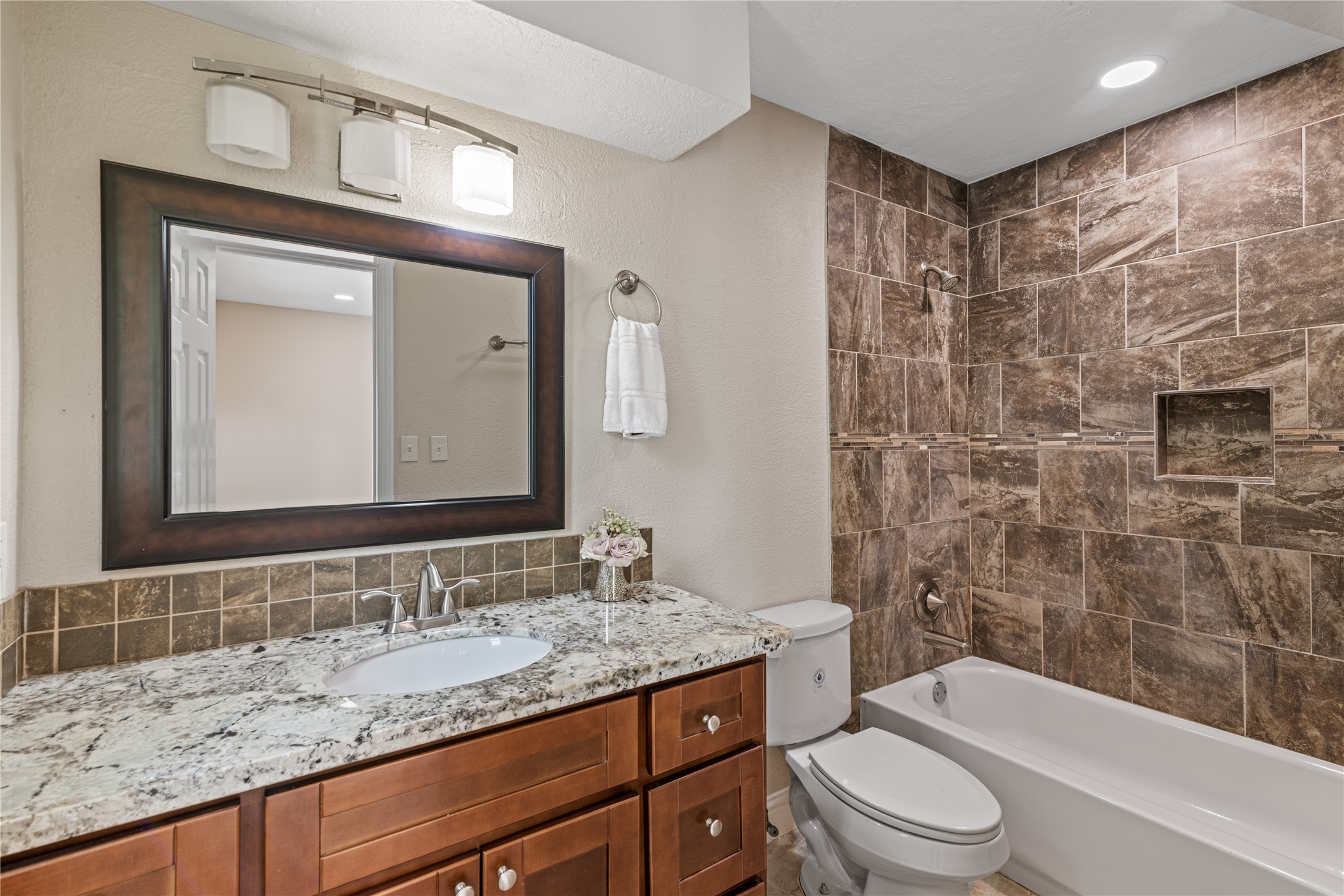 16027 Barbara Lane Magnolia, TX 77355 - Photo 19 of 40 a bathroom with a granite countertop sink toilet mirror and shower