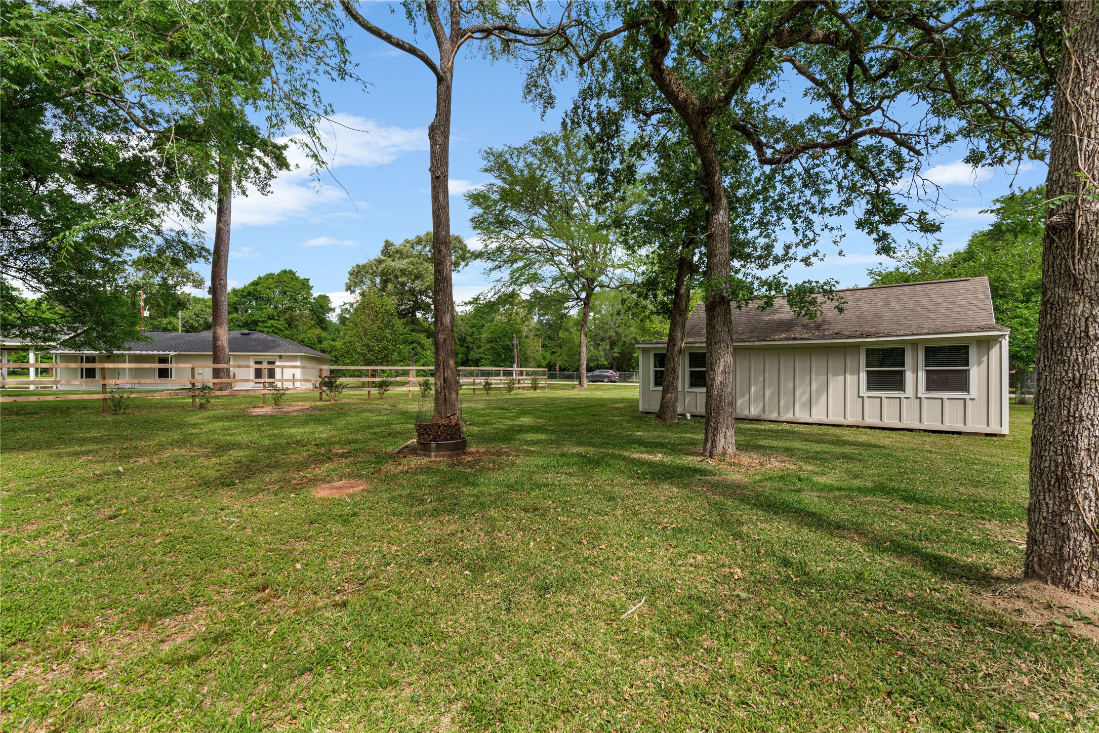 16027 Barbara Lane Magnolia, TX 77355 - Photo 23 of 40 a backyard of a house with lots of green space and fountain