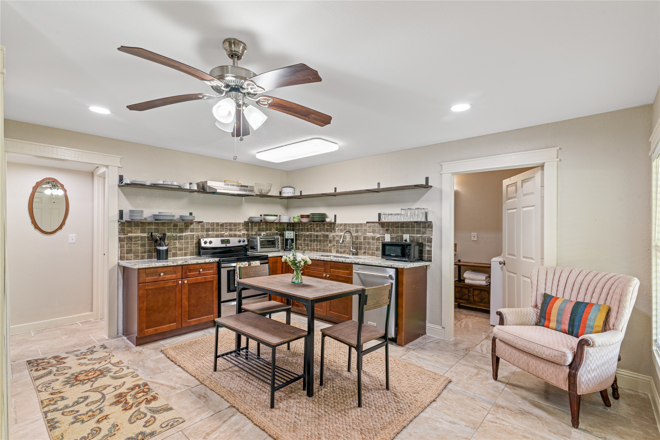 16027 Barbara Lane Magnolia, TX 77355 - Photo 24 of 40 a room with stainless steel appliances kitchen island granite countertop furniture and a rug