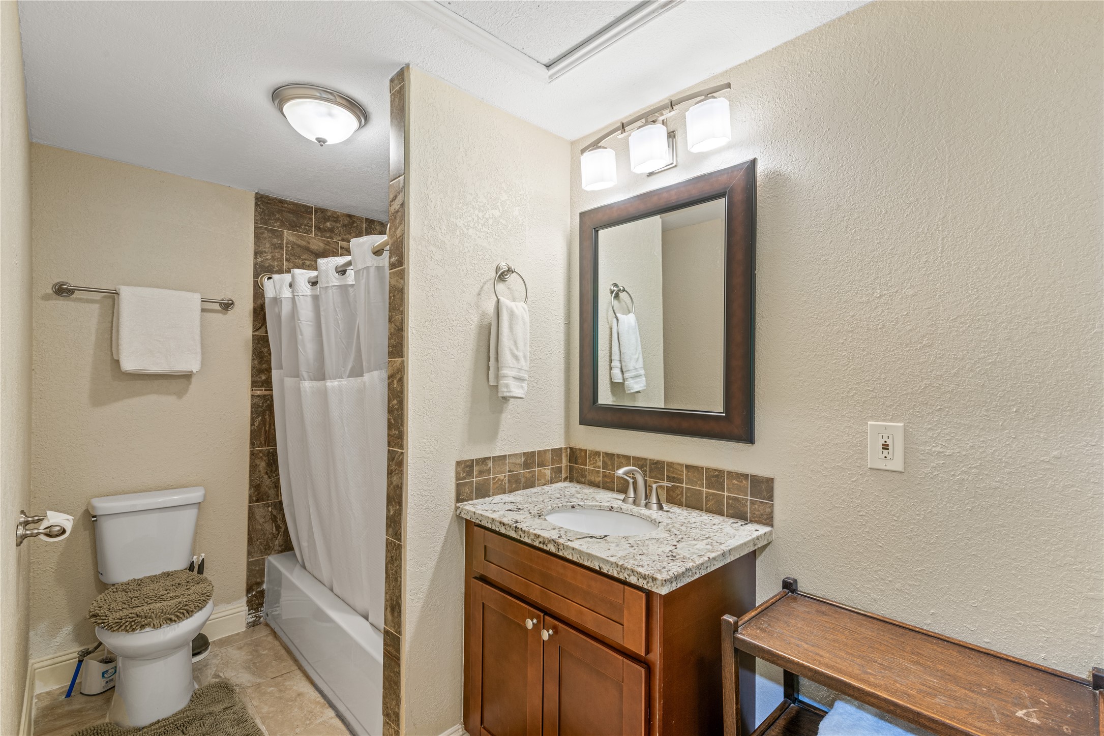 16027 Barbara Lane Magnolia, TX 77355 - Photo 28 of 40 a bathroom with a sink a toilet and shower a mirror