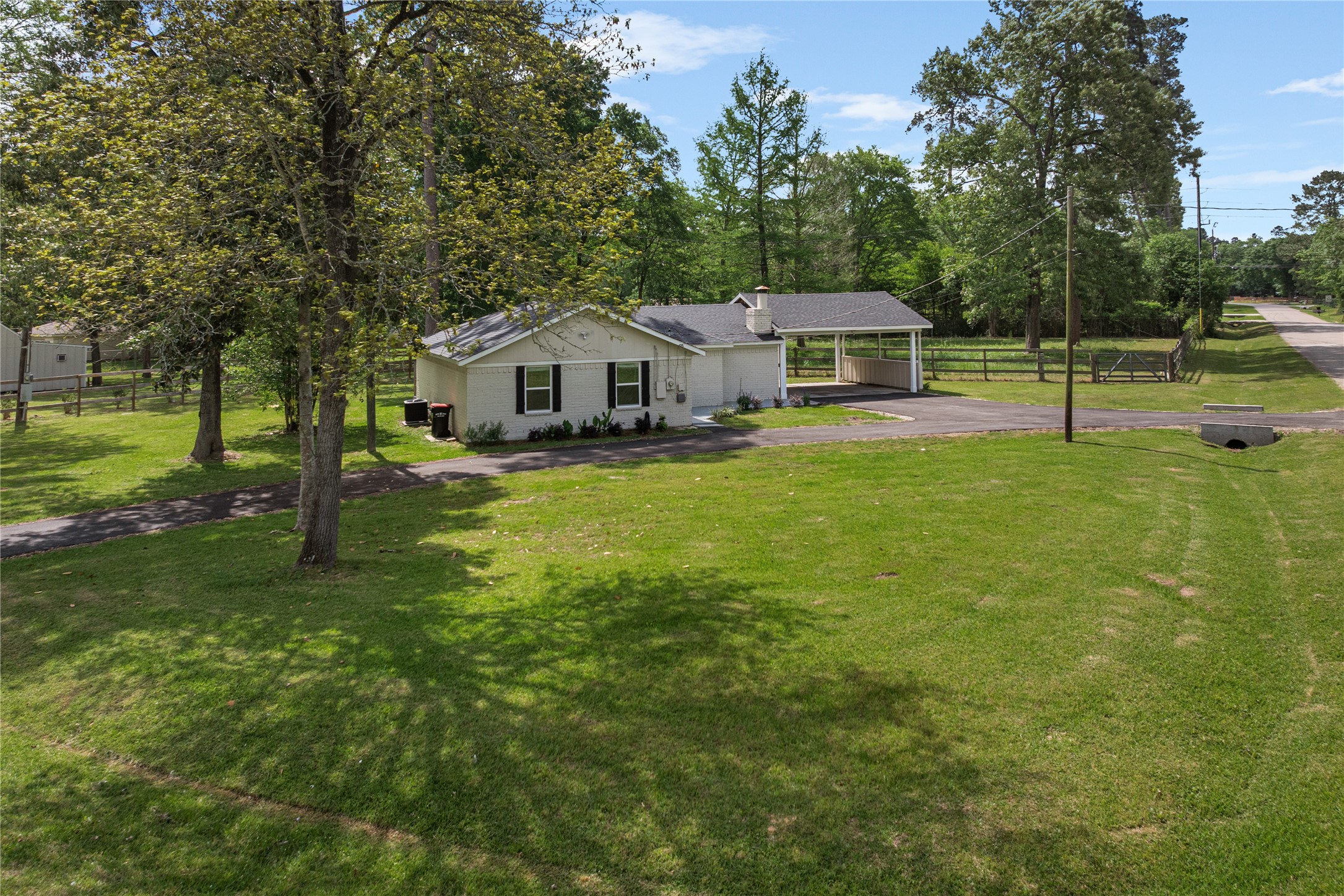 16027 Barbara Lane Magnolia, TX 77355 - Photo 34 of 40 a front view of a house with a yard and trees