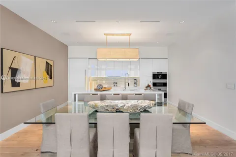 a view of a kitchen with kitchen island and stainless steel appliances