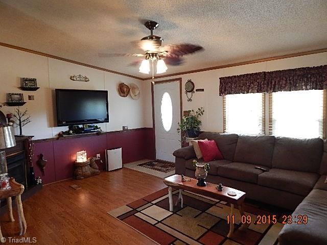 1036 Barn Road Walnut Cove, NC 27052 - Photo 3 of 24 Spacious living room with laminate flooring.