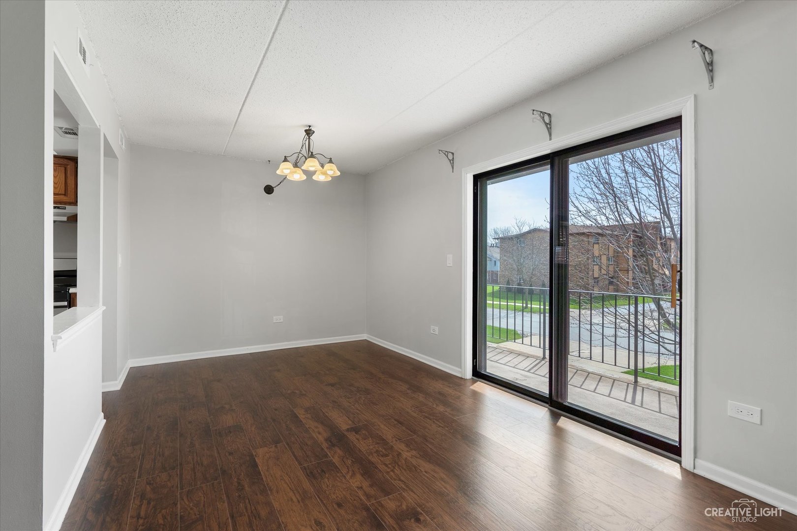 1239 Chalet Road, Unit 200 Naperville, IL 60563 - Photo 2 of 16 wooden floor in an empty room with a window