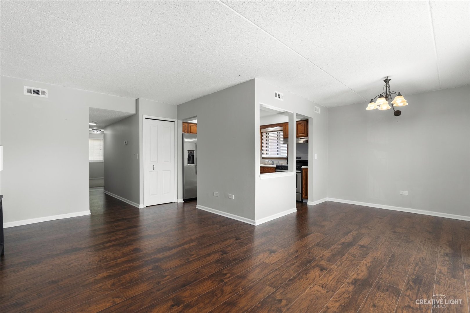 1239 Chalet Road, Unit 200 Naperville, IL 60563 - Photo 3 of 16 an empty room with wooden floor