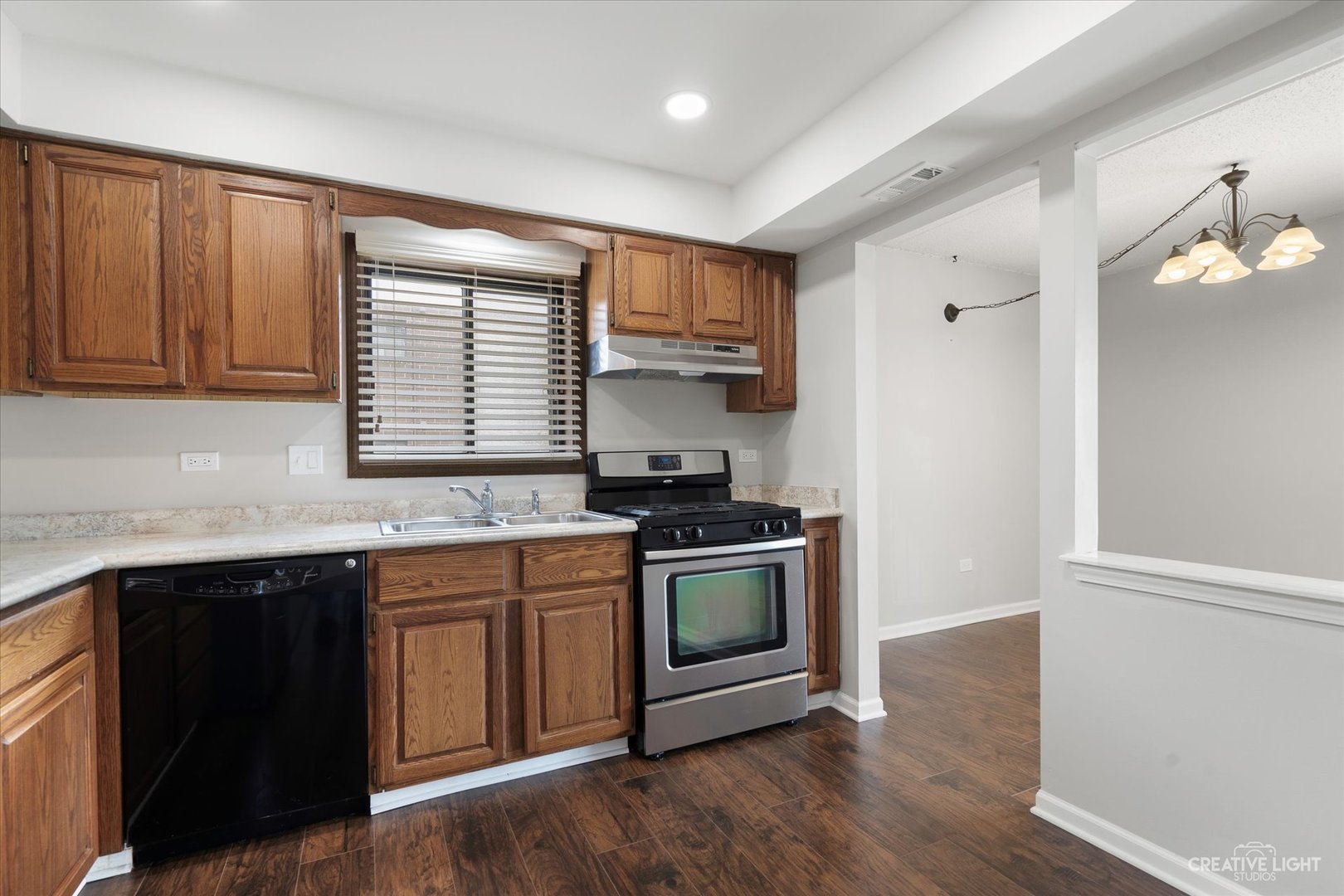 1239 Chalet Road, Unit 200 Naperville, IL 60563 - Photo 5 of 16 a kitchen with stainless steel appliances granite countertop a stove a sink and a microwave