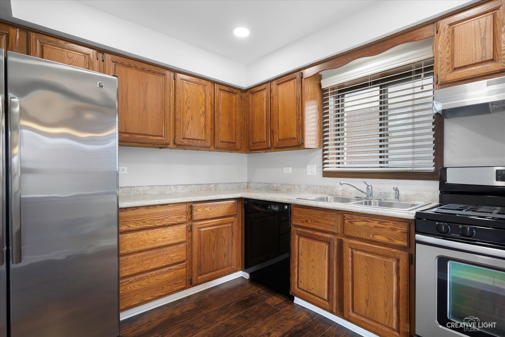 1239 Chalet Road, Unit 200 Naperville, IL 60563 - Photo 7 of 16 a kitchen with stainless steel appliances granite countertop a stove a sink and a microwave