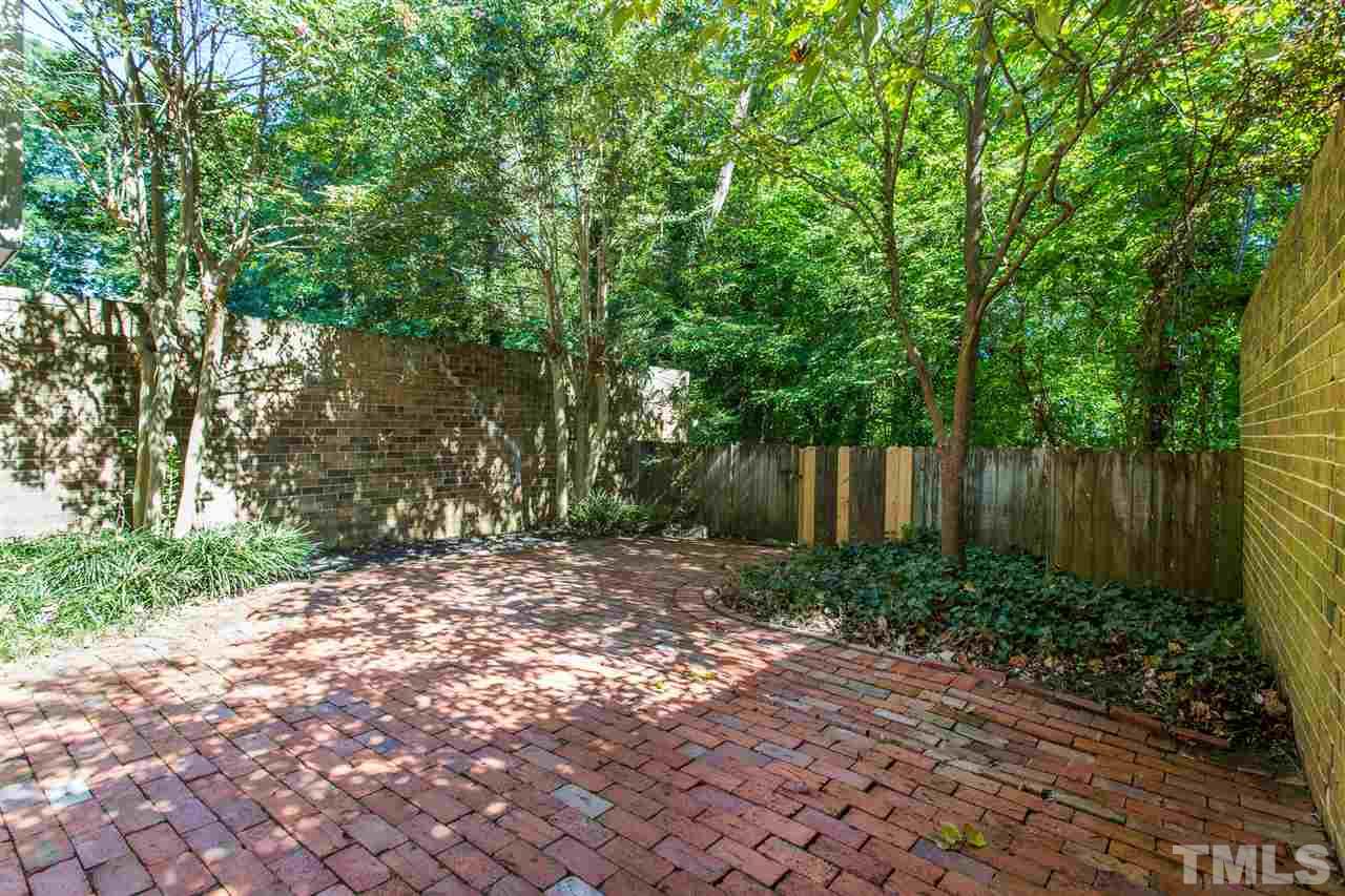 2856 Wycliff Road Raleigh, NC 27607 - Photo 4 of 29 a view of a backyard with plants and large trees