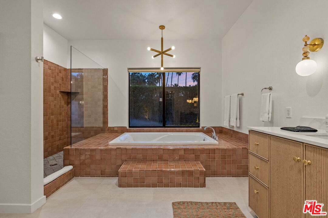 1414 Sagebrush Road Palm Springs, CA 92264 - Photo 26 of 48 a room with granite countertop a walk in closet and chandelier