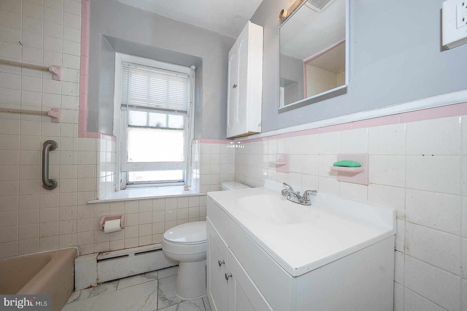 169 Overhill Road Upper Darby, PA 19082 - Photo 35 of 69 a bathroom with a sink a toilet and a window
