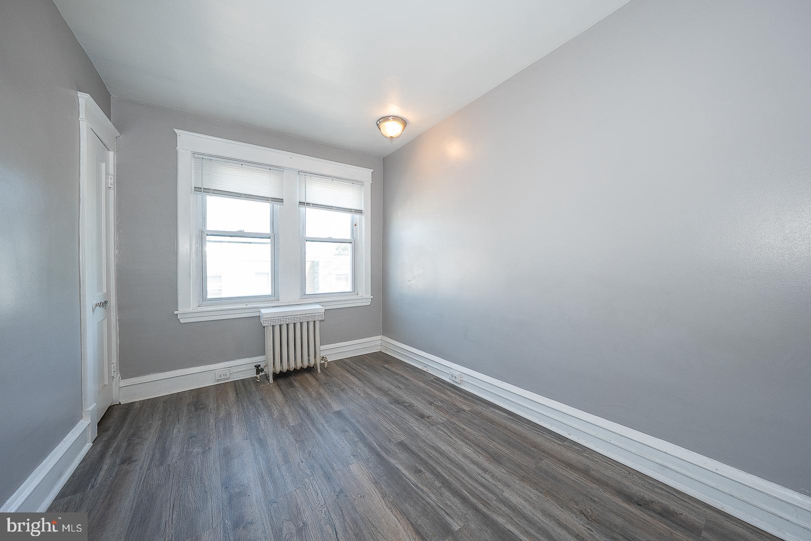 169 Overhill Road Upper Darby, PA 19082 - Photo 37 of 69 an empty room with wooden floor and windows
