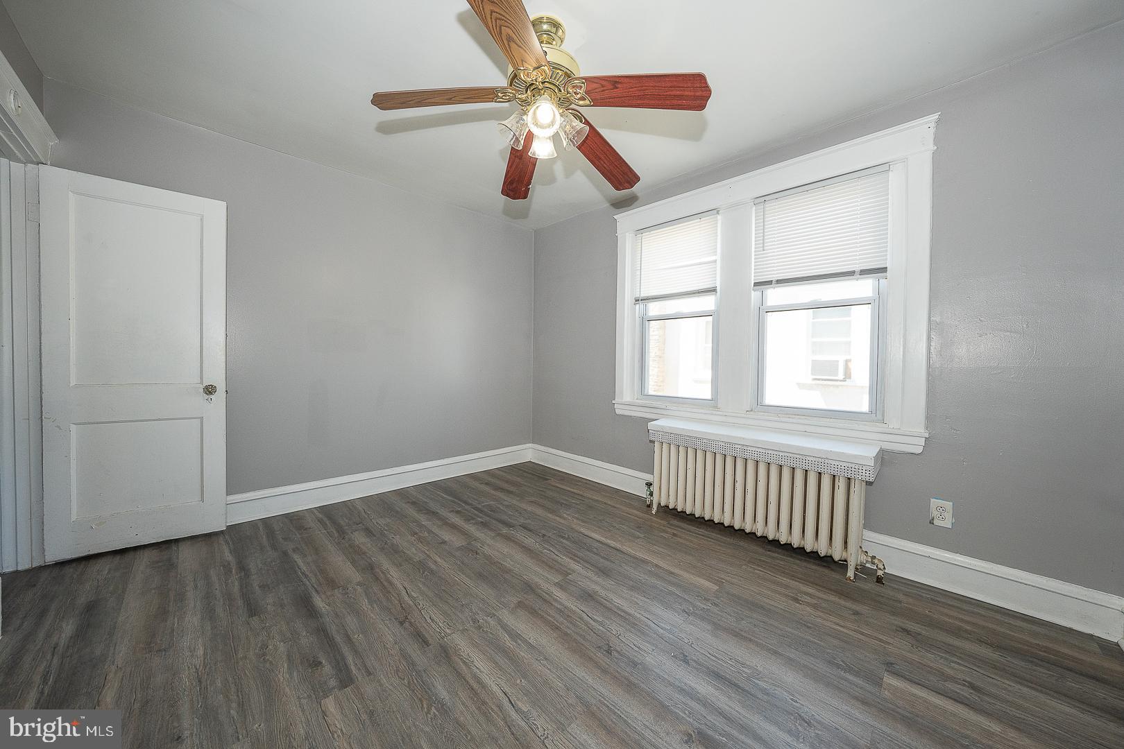 169 Overhill Road Upper Darby, PA 19082 - Photo 42 of 69 an empty room with wooden floor chandelier fan and windows