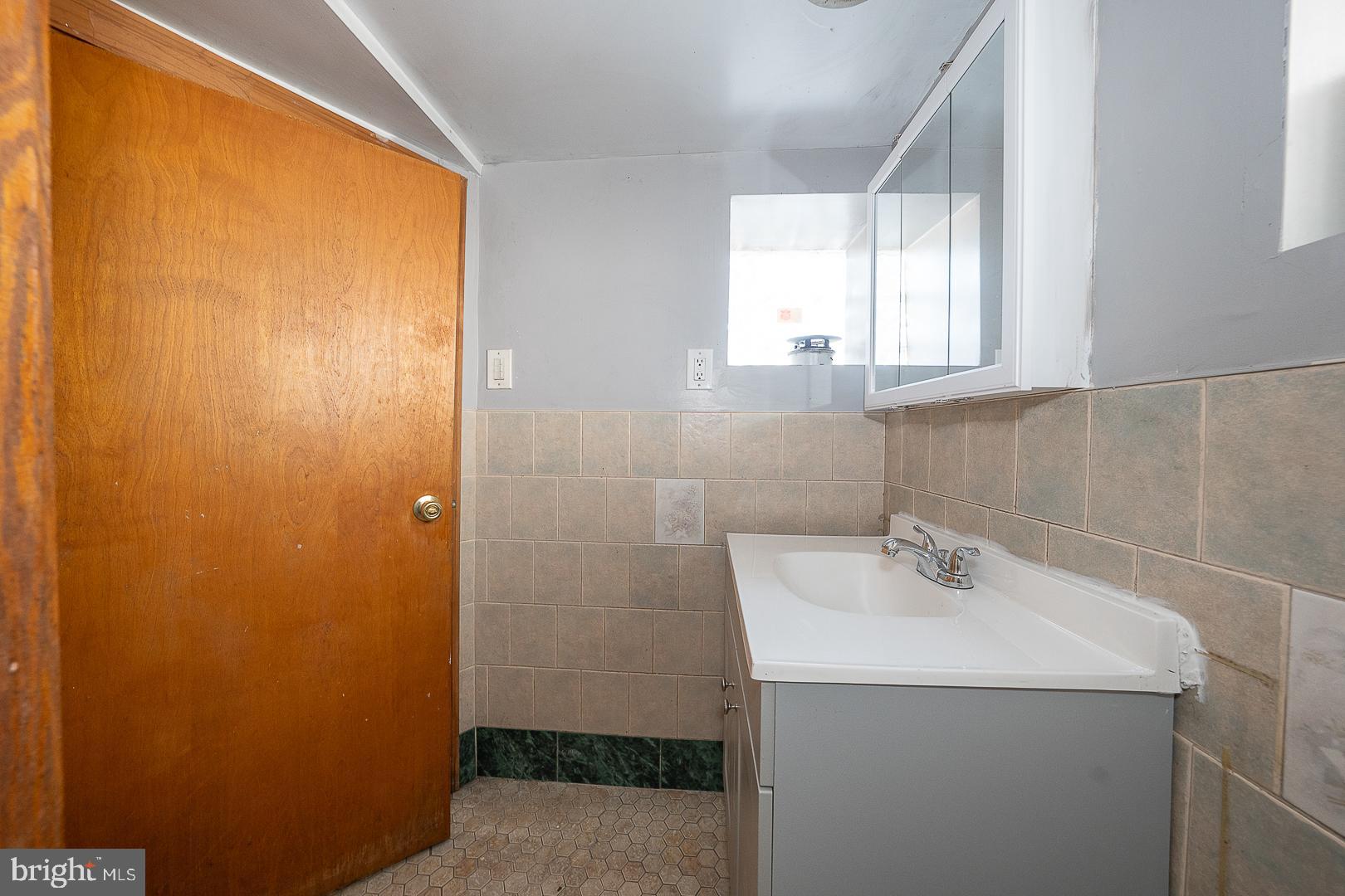 169 Overhill Road Upper Darby, PA 19082 - Photo 51 of 69 a bathroom with a sink and a mirror