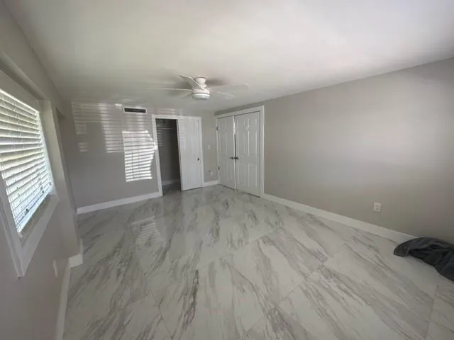 a view of an empty room and a window