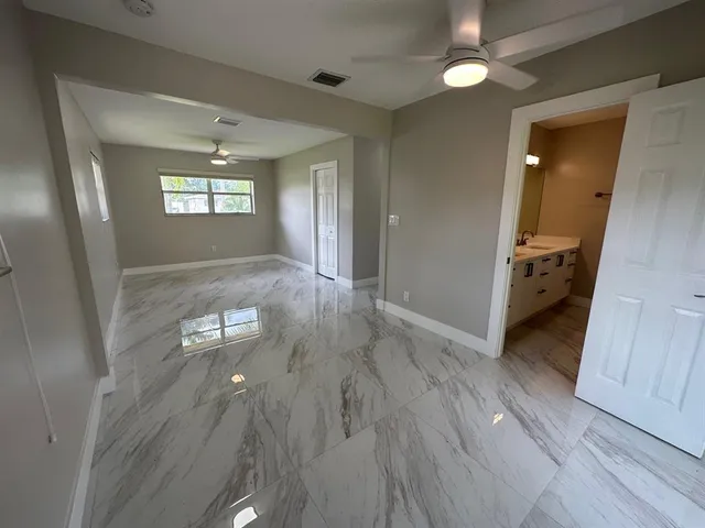 a bathroom with a shower sink mirror and toilet