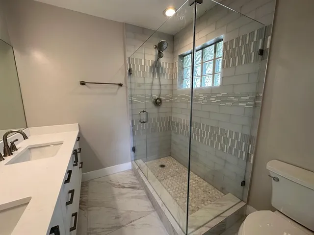 a bathroom with a sink toilet and shower