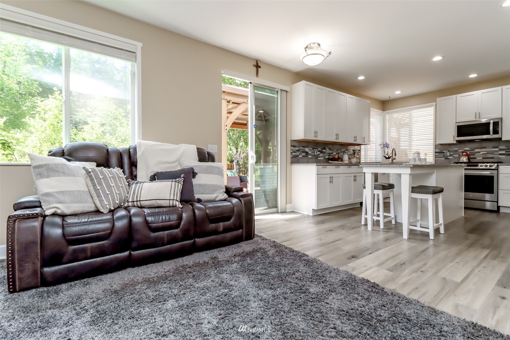 28035 Maple Ridge Way Southeast Maple Valley, WA 98038 - Photo 14 of 40 a living room with furniture a large window and stainless steel appliances