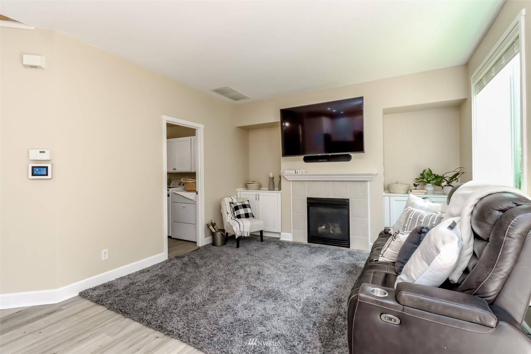 28035 Maple Ridge Way Southeast Maple Valley, WA 98038 - Photo 15 of 40 a living room with furniture a flat screen tv and a fireplace