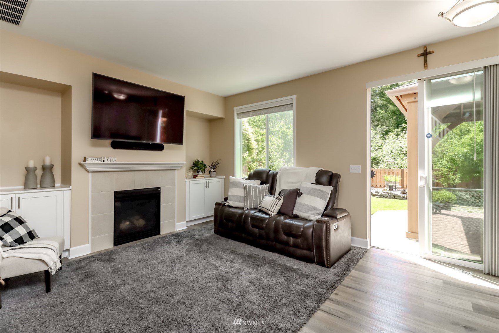 28035 Maple Ridge Way Southeast Maple Valley, WA 98038 - Photo 16 of 40 a living room with furniture a flat screen tv and a fireplace
