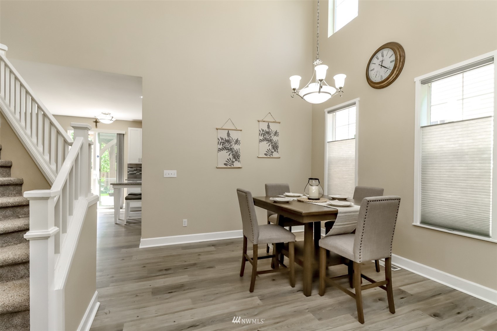 28035 Maple Ridge Way Southeast Maple Valley, WA 98038 - Photo 17 of 40 a view of a dining room with furniture a chandelier and wooden floor