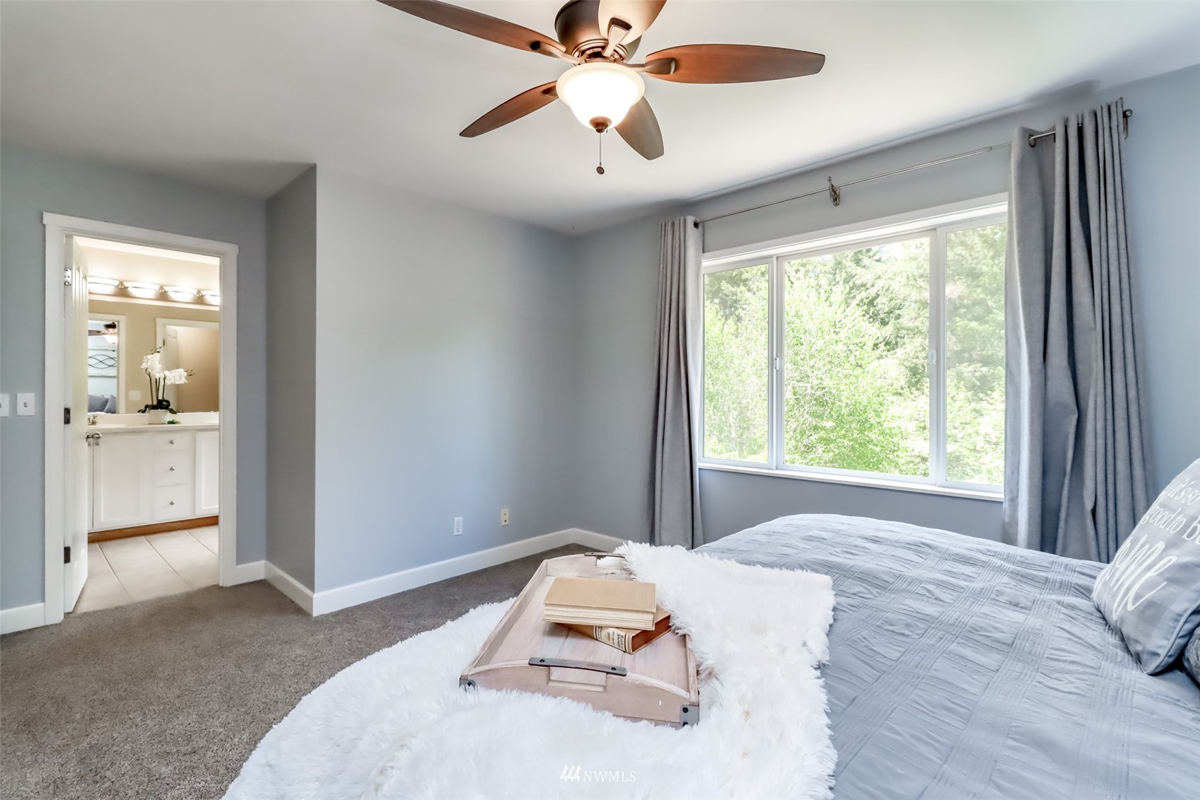 28035 Maple Ridge Way Southeast Maple Valley, WA 98038 - Photo 28 of 40 a bedroom with a bed and a chandelier