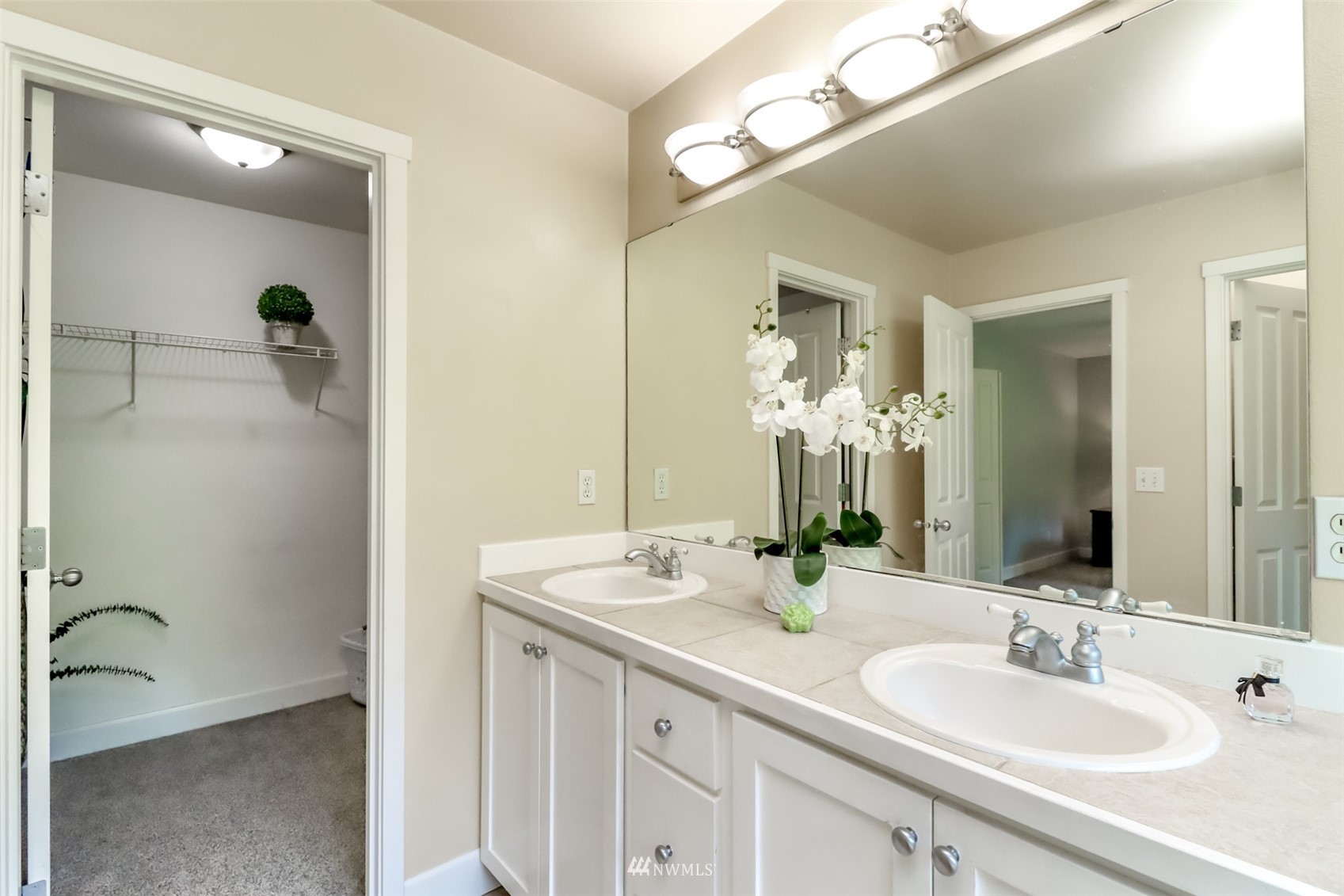 28035 Maple Ridge Way Southeast Maple Valley, WA 98038 - Photo 30 of 40 a bathroom with a double vanity sink a mirror and a bathtub