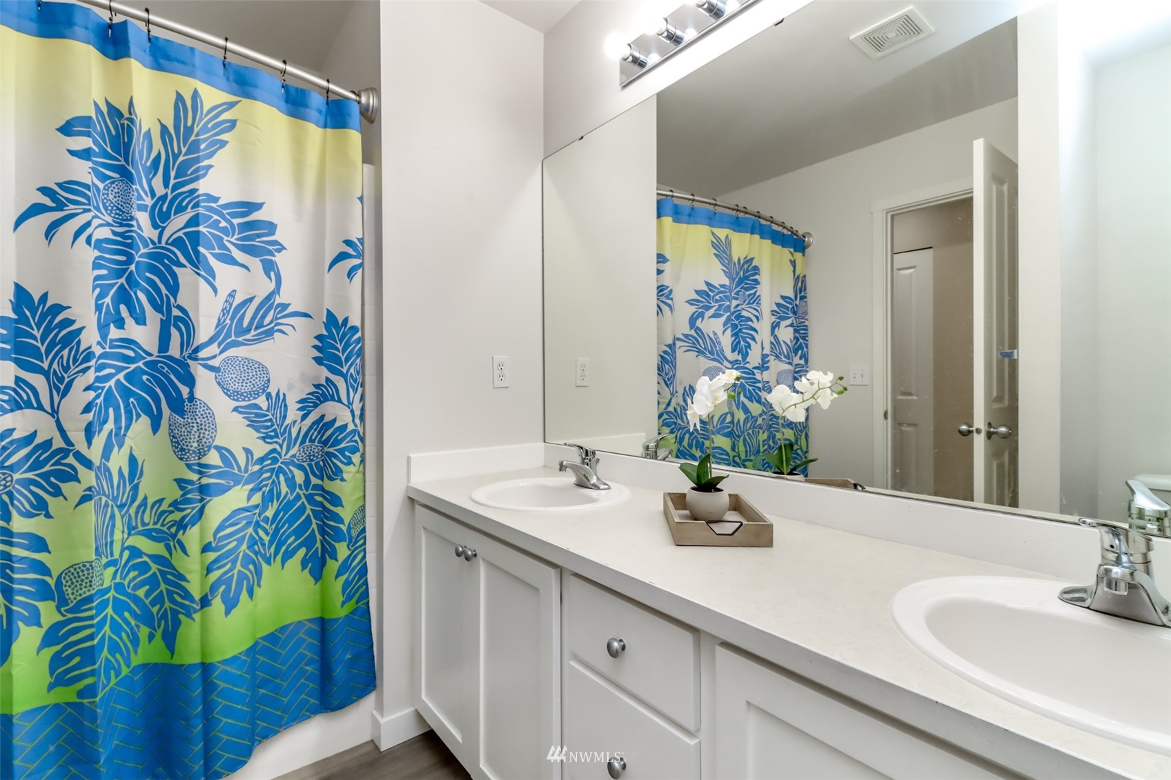 28035 Maple Ridge Way Southeast Maple Valley, WA 98038 - Photo 32 of 40 a bathroom with a sink a mirror and a shower curtain