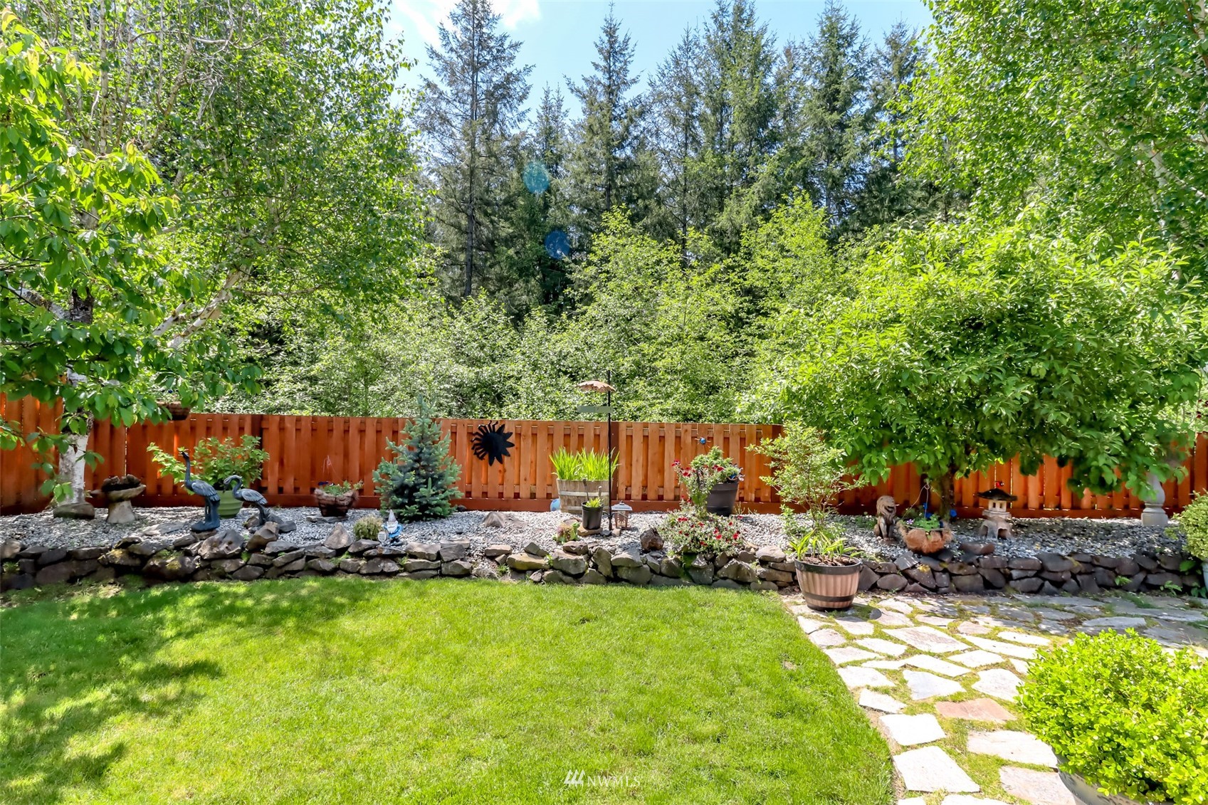 28035 Maple Ridge Way Southeast Maple Valley, WA 98038 - Photo 33 of 40 a view of backyard with wooden fence and a slide