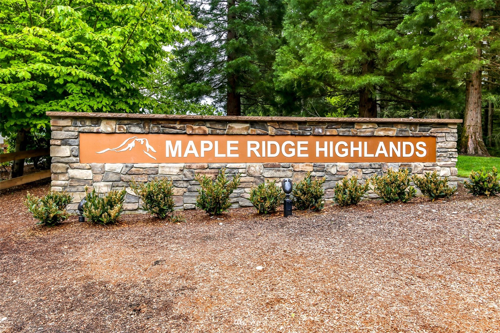 28035 Maple Ridge Way Southeast Maple Valley, WA 98038 - Photo 39 of 40 a street sign that is sitting on a brick wall
