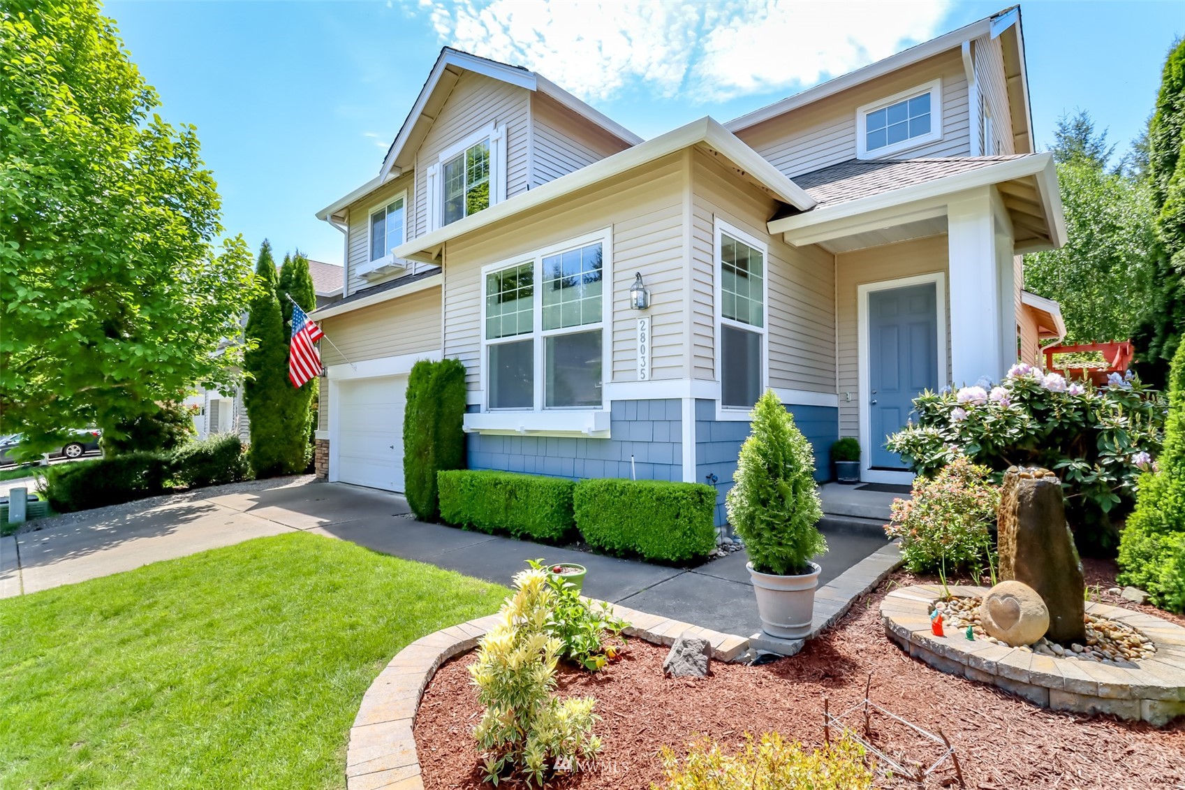 28035 Maple Ridge Way Southeast Maple Valley, WA 98038 - Photo 40 of 40 a front view of a house with a yard and potted plants