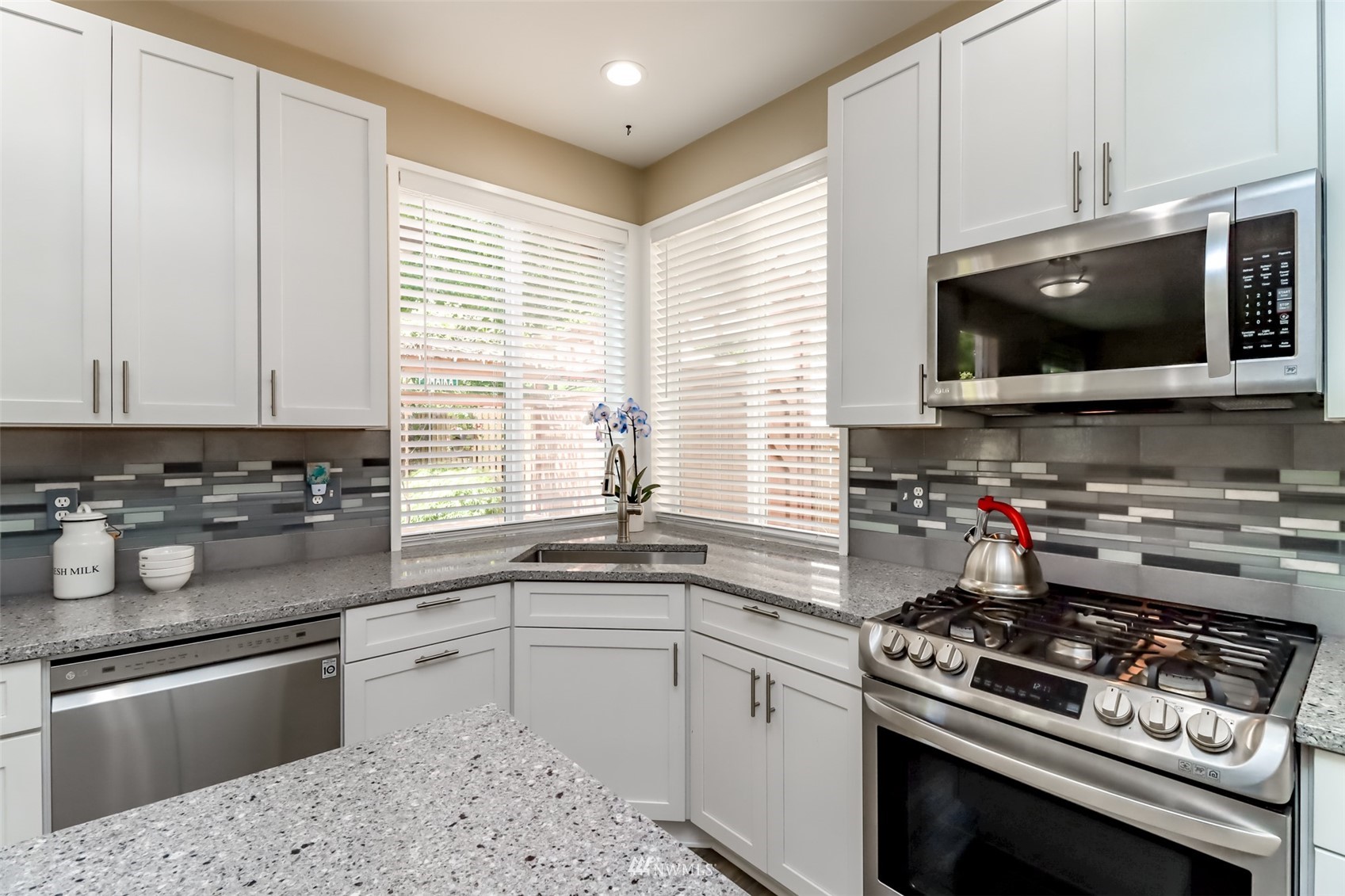 28035 Maple Ridge Way Southeast Maple Valley, WA 98038 - Photo 10 of 40 a kitchen with a stove a sink and a microwave