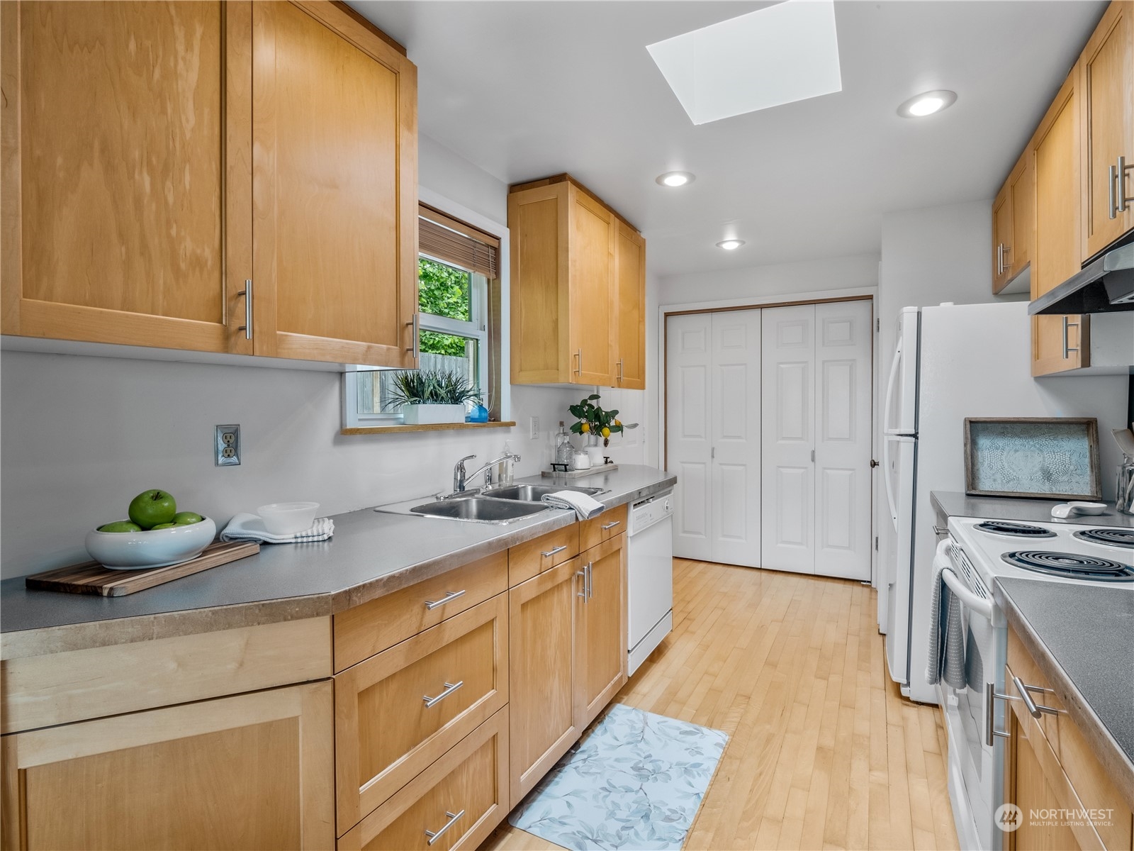 8414 14th Avenue Southwest Seattle, WA 98106 - Photo 4 of 20 a kitchen with a sink a counter top space stainless steel appliances and cabinets