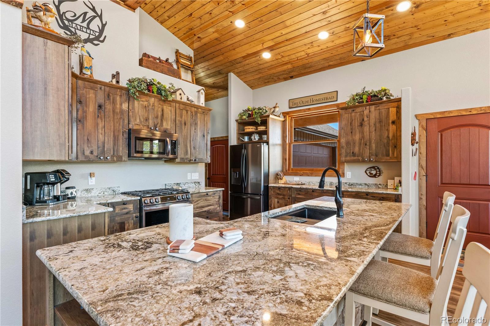 1310 Sunrise Ridge Cotopaxi, CO 81223 - Photo 31 of 50 a kitchen with stainless steel appliances granite countertop a sink stove and refrigerator