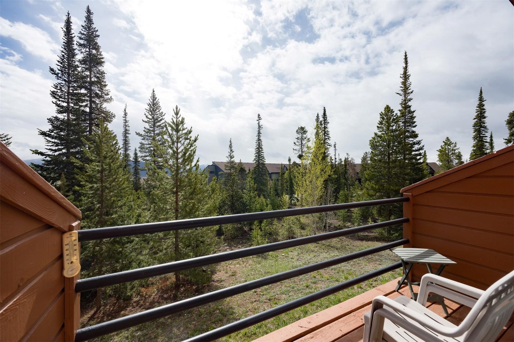 91100 Ryan Gulch Road, Unit 91105 Silverthorne, CO 80498 - Photo 19 of 49 a view of a balcony with wooden fence and trees
