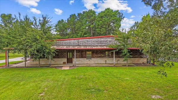 a view of a house with a backyard porch and sitting area