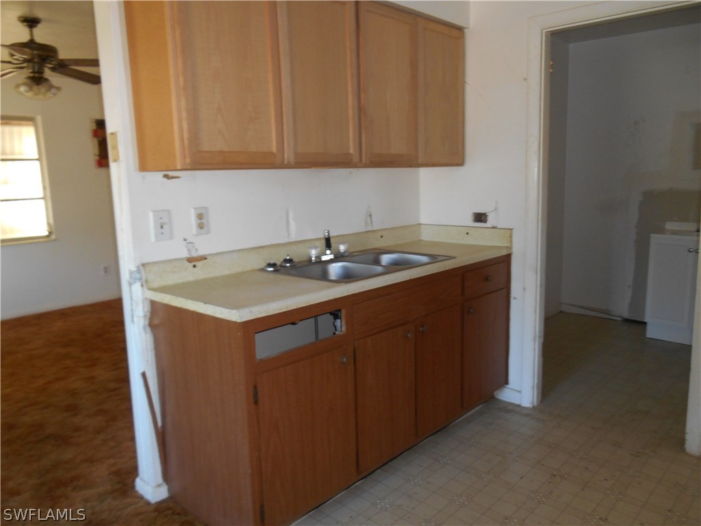 512 Wyoming Road Lehigh Acres, FL 33936 - Photo 6 of 17 a utility room with a sink