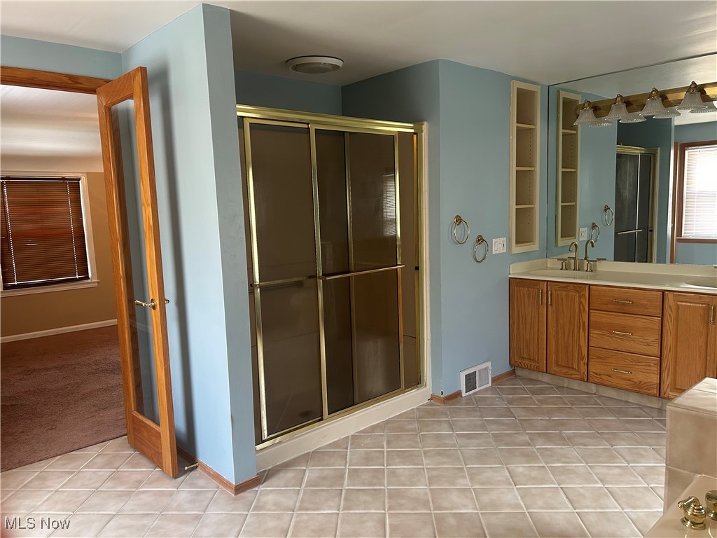 1194 Croyden Road Lyndhurst, OH 44124 - Photo 20 of 25 Bathroom with light tile patterned flooring, double vanity, and a shower stall
