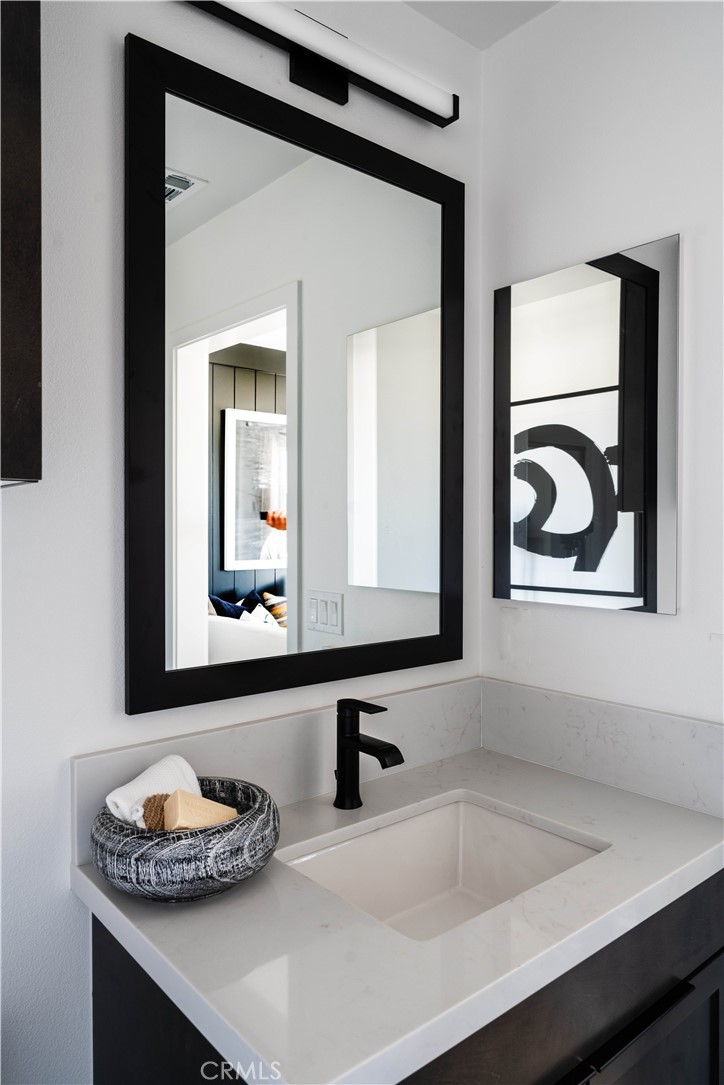 1752 West Sycamore Drive Compton, CA 90220 - Photo 18 of 21 a bathroom with a sink and a mirror