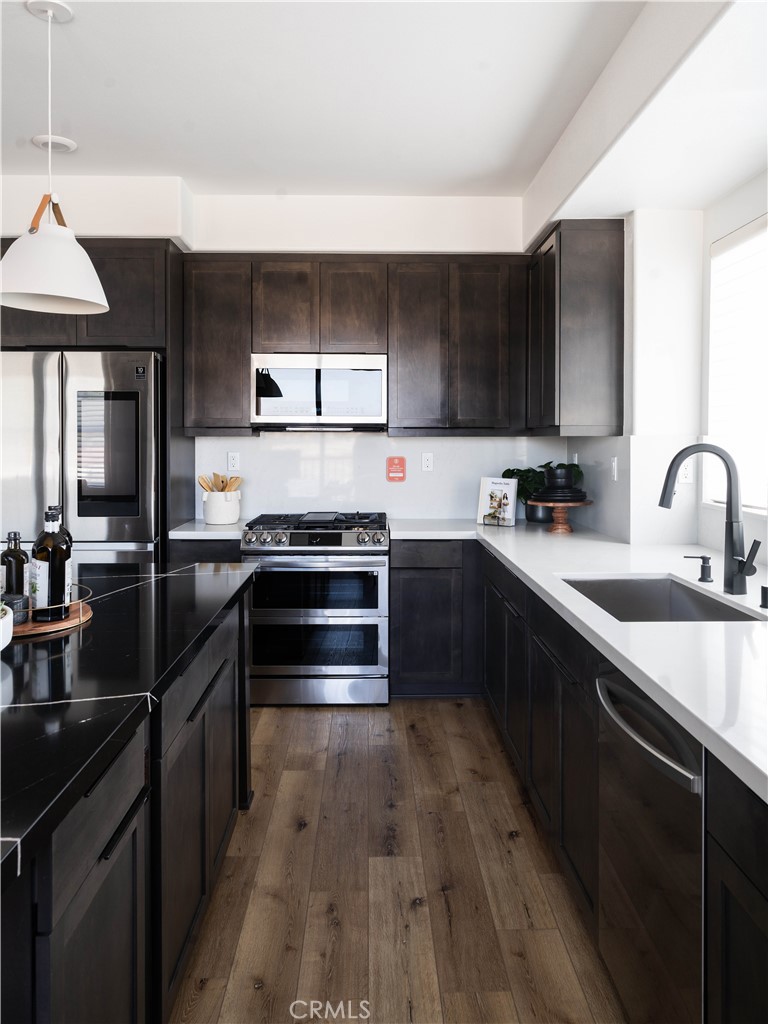 1752 West Sycamore Drive Compton, CA 90220 - Photo 7 of 21 a kitchen with a sink appliances and cabinets