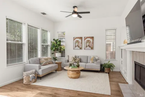 a living room with furniture a flat screen tv and a fireplace